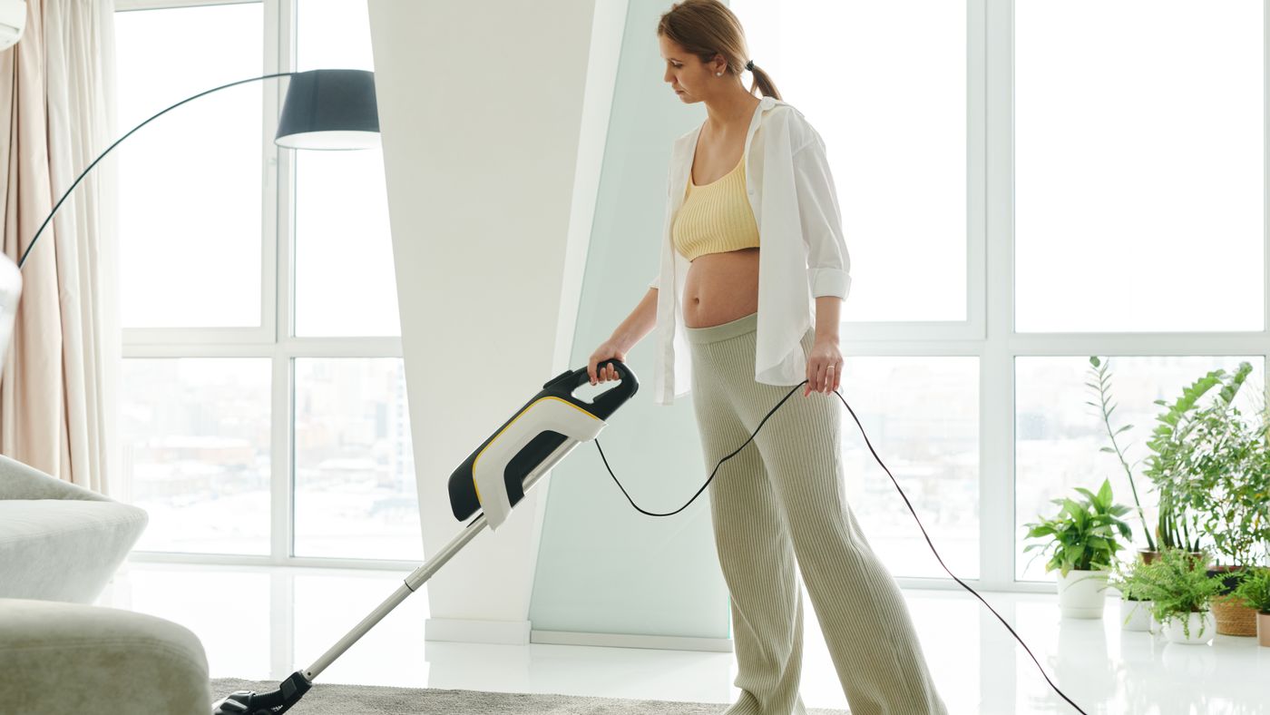 woman vacuuming a rug