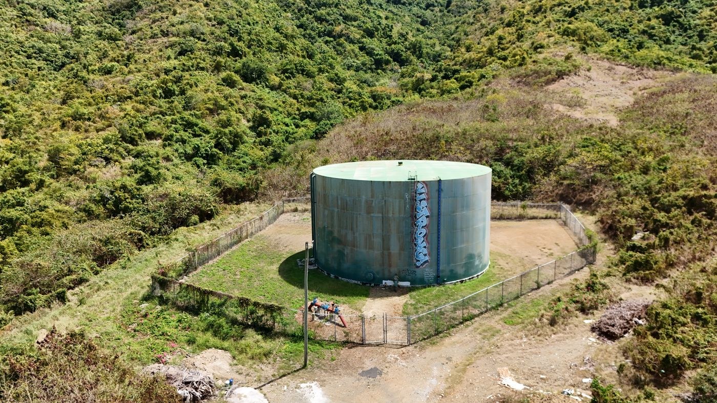 large water storage tank surrounded by greenery